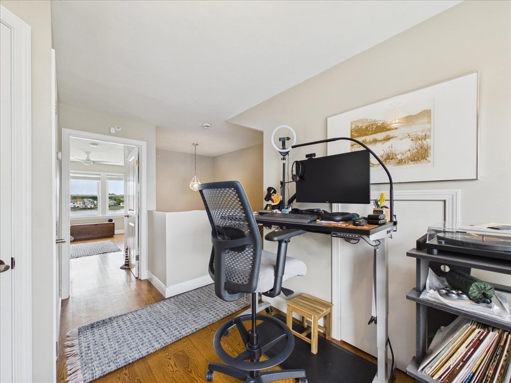 7 Bay Street, Unit 3 Hull, MA 02045 - Photo 26 of 40 a view of a workspace with furniture and a flat screen tv