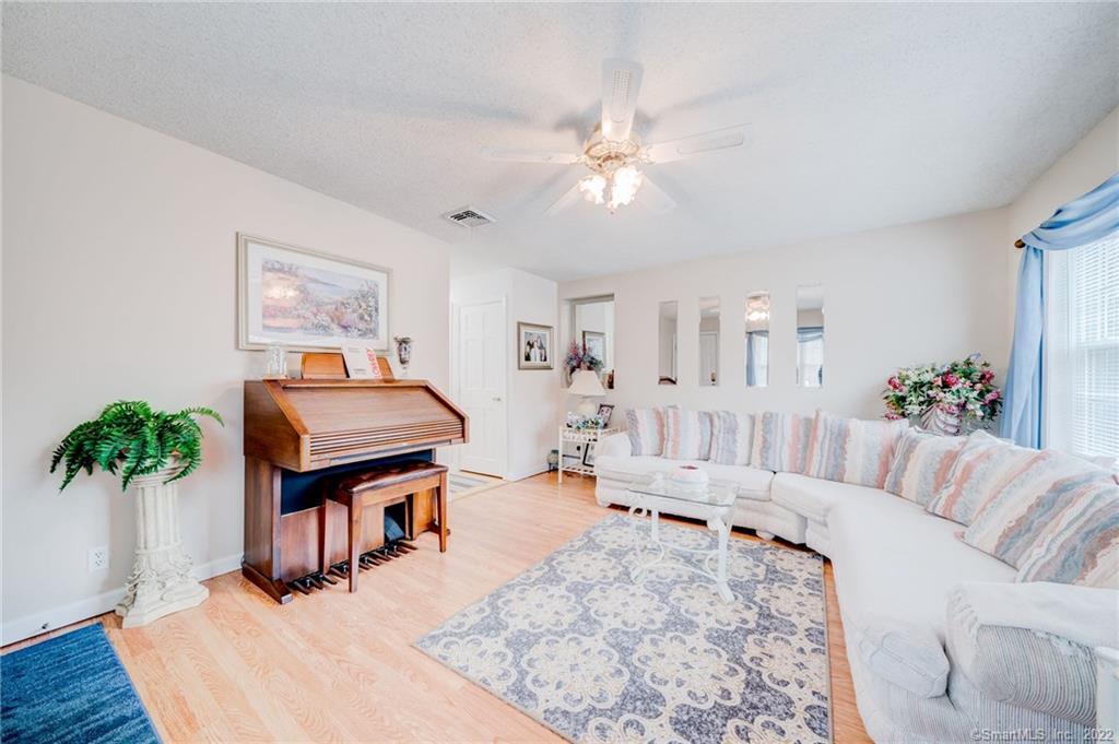 311 Bedlam Road Chaplin, CT 06235 - Photo 1 of 1 a living room with furniture and a chandelier