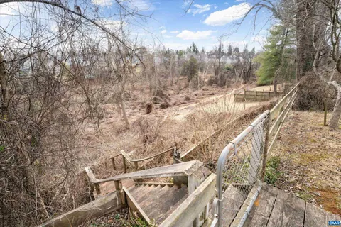 a view of a pathway with a wrought fence