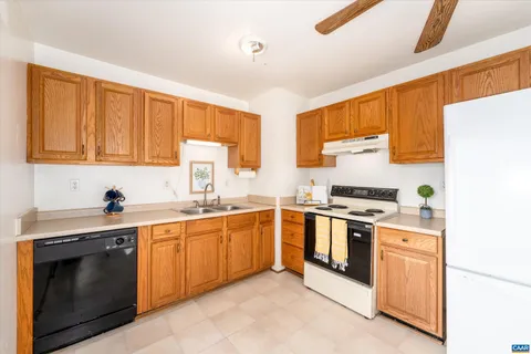 a kitchen with stainless steel appliances granite countertop a stove sink and cabinets