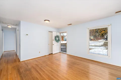 a view of empty room with wooden floor