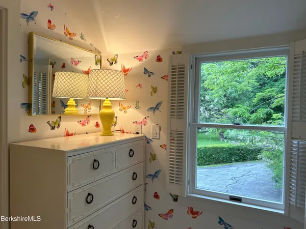 a bathroom with a granite countertop sink mirror and window