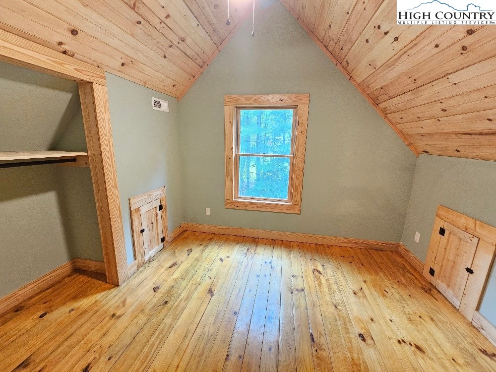 184 Presnell Road Sparta, NC 28675 - Photo 20 of 30 a view of an empty room with wooden floor and a window