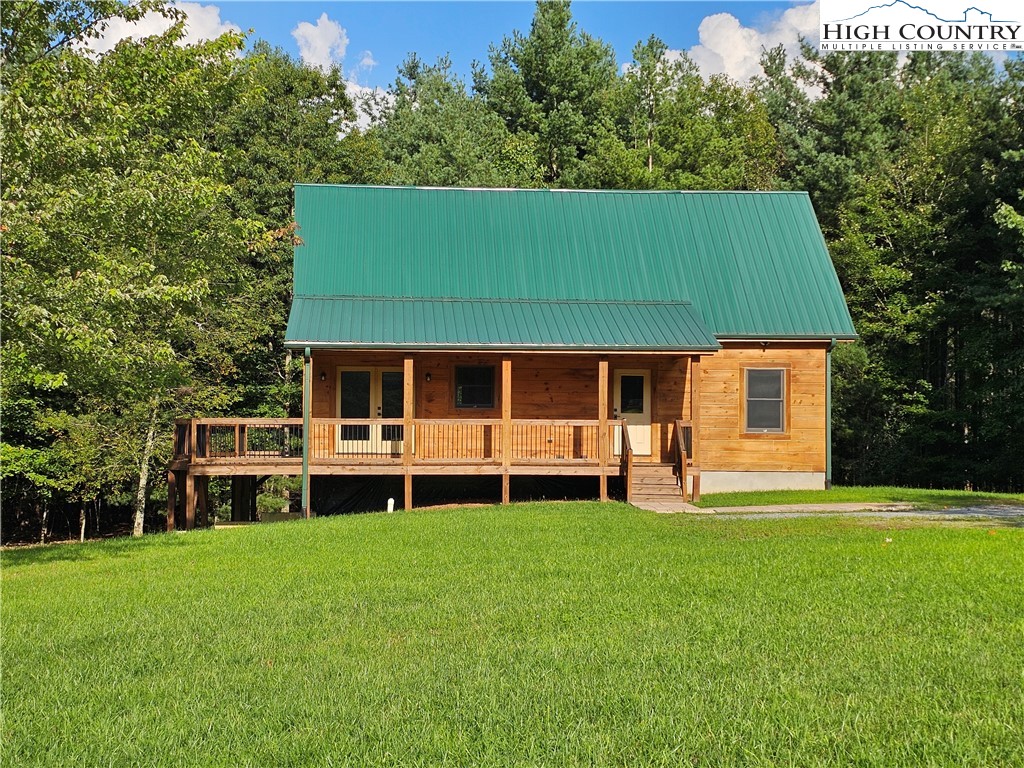 184 Presnell Road Sparta, NC 28675 - Photo 5 of 30 a house view with a sitting space and garden