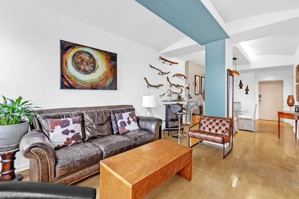 a living room with furniture and painting on the wall