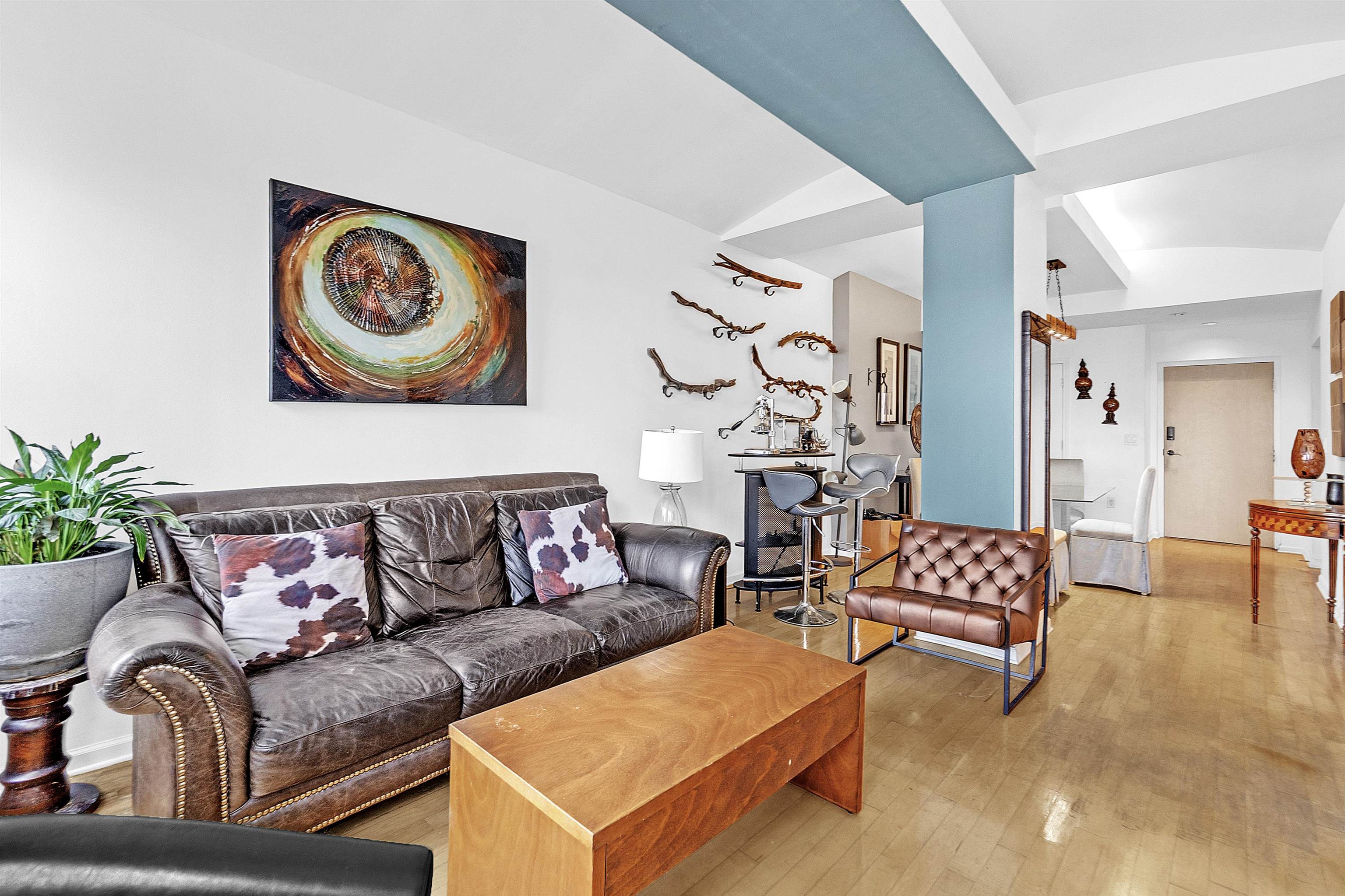 66 Monroe Avenue, Unit 606 Memphis, TN 38103 - Photo 1 of 9 a living room with furniture and painting on the wall