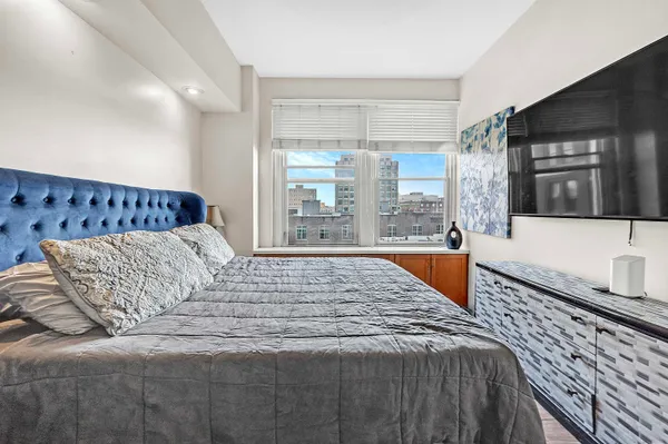 a bedroom with a large bed and a large window