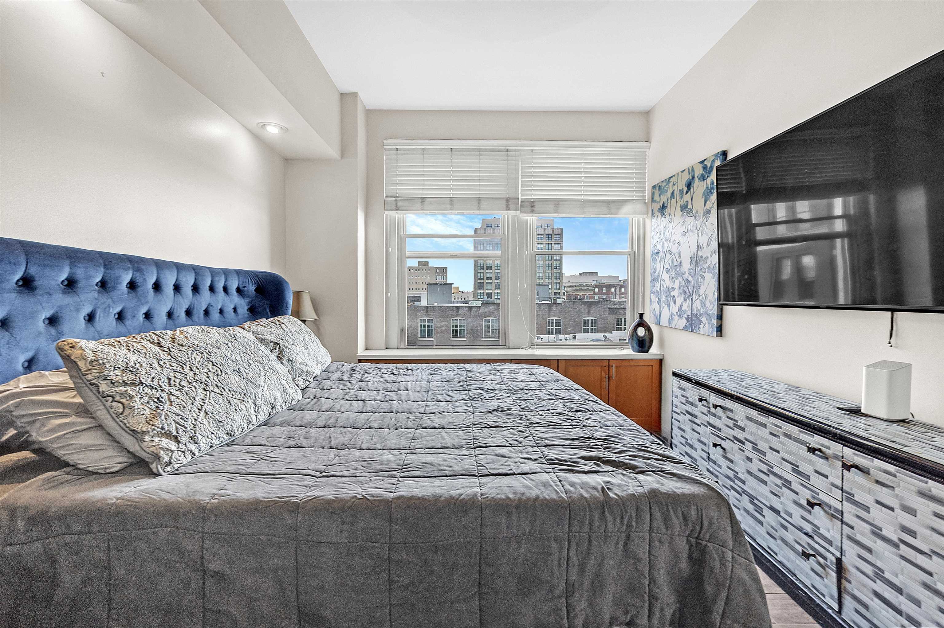 66 Monroe Avenue, Unit 606 Memphis, TN 38103 - Photo 6 of 9 a bedroom with a large bed and a large window