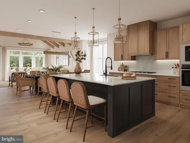 a kitchen with granite countertop a table chairs stove a sink and dishwasher