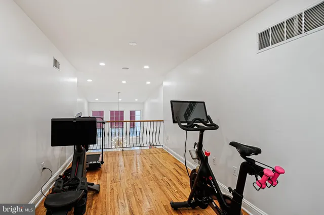 a hallway with table and a closet