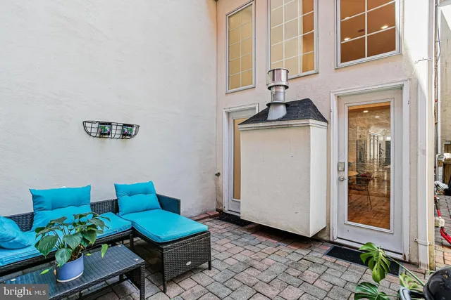 a front view of a house with outdoor seating