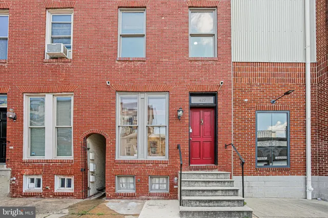 a front view of a brick building with a door and a window