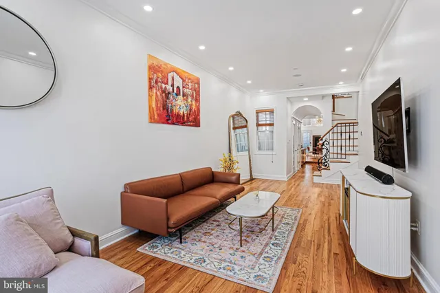 a living room with furniture and a flat screen tv