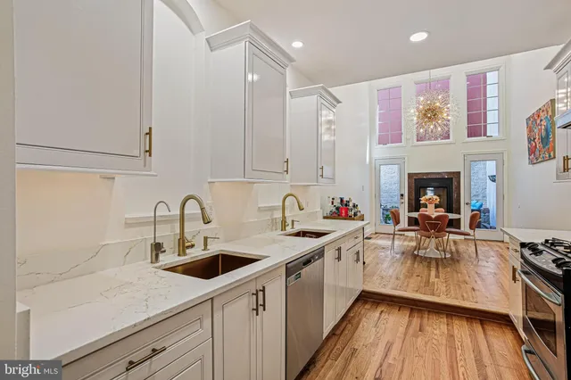 a kitchen with a sink cabinets and wooden floor