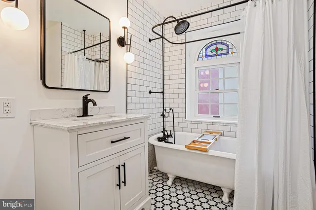 a bathroom with a sink a vanity and a shower