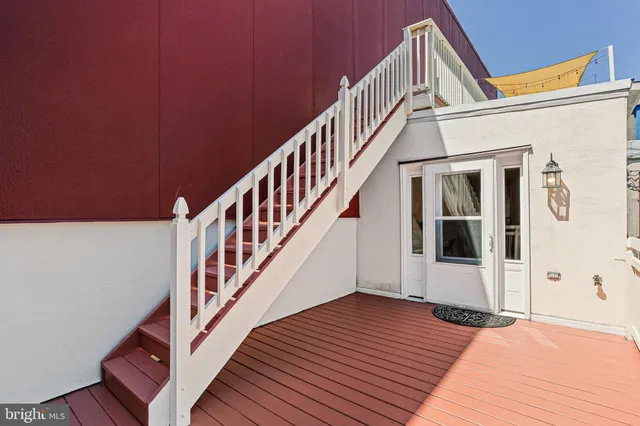 a view of entryway with wooden floor and stairs