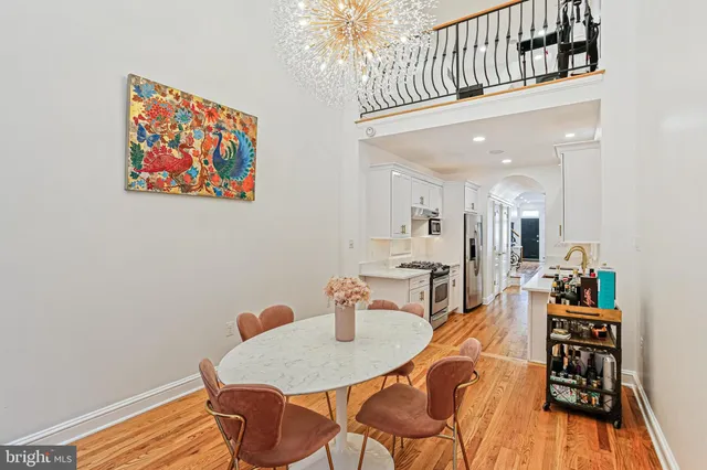 a view of a dining room with furniture and wooden floor