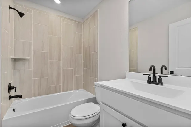 a bathroom with a sink a toilet and a bathtub