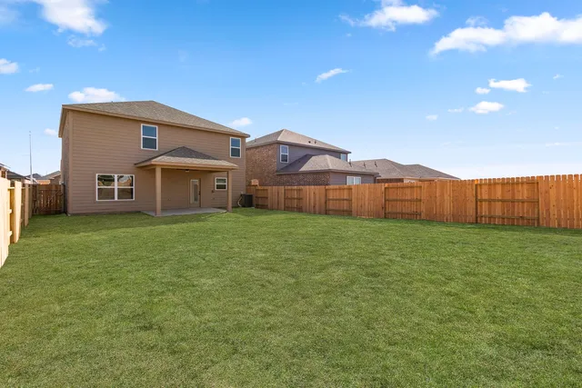 a front view of house with yard and car parked