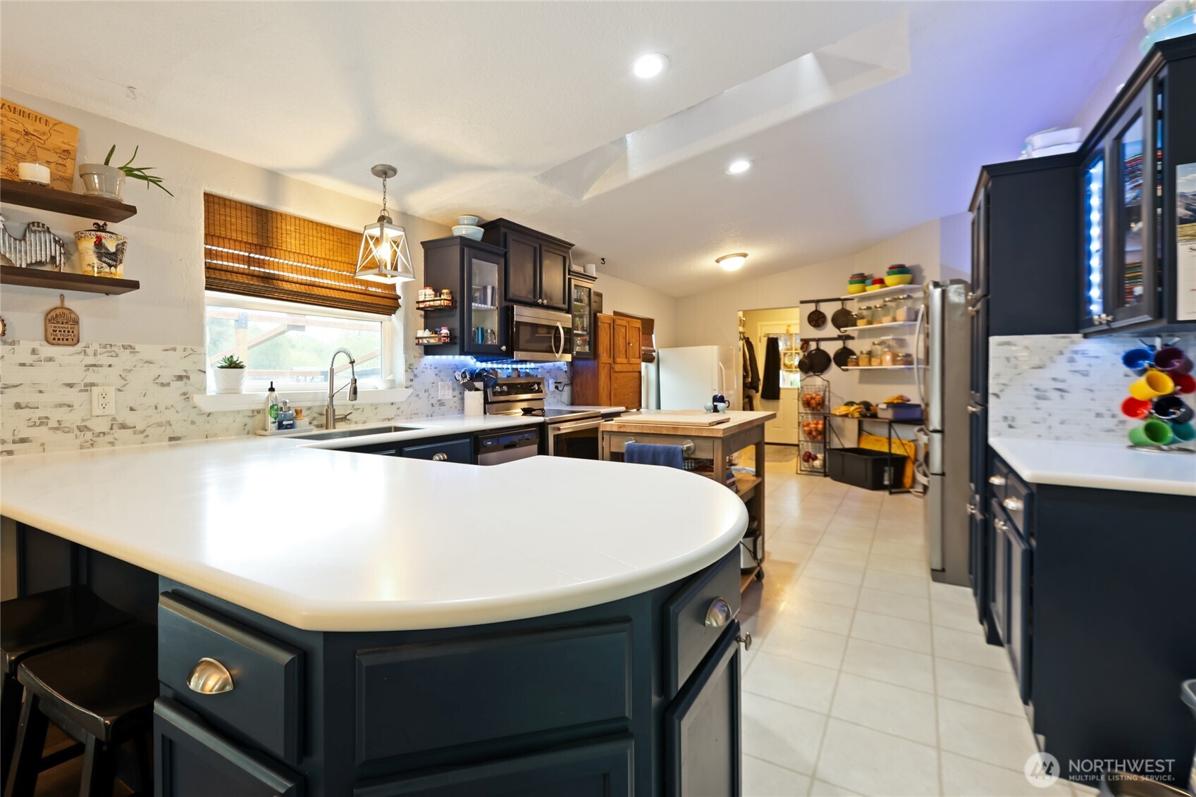 6509 176th Avenue Southwest Longbranch, WA 98351 - Photo 8 of 32 a kitchen with stainless steel appliances granite countertop a sink a stove and a refrigerator