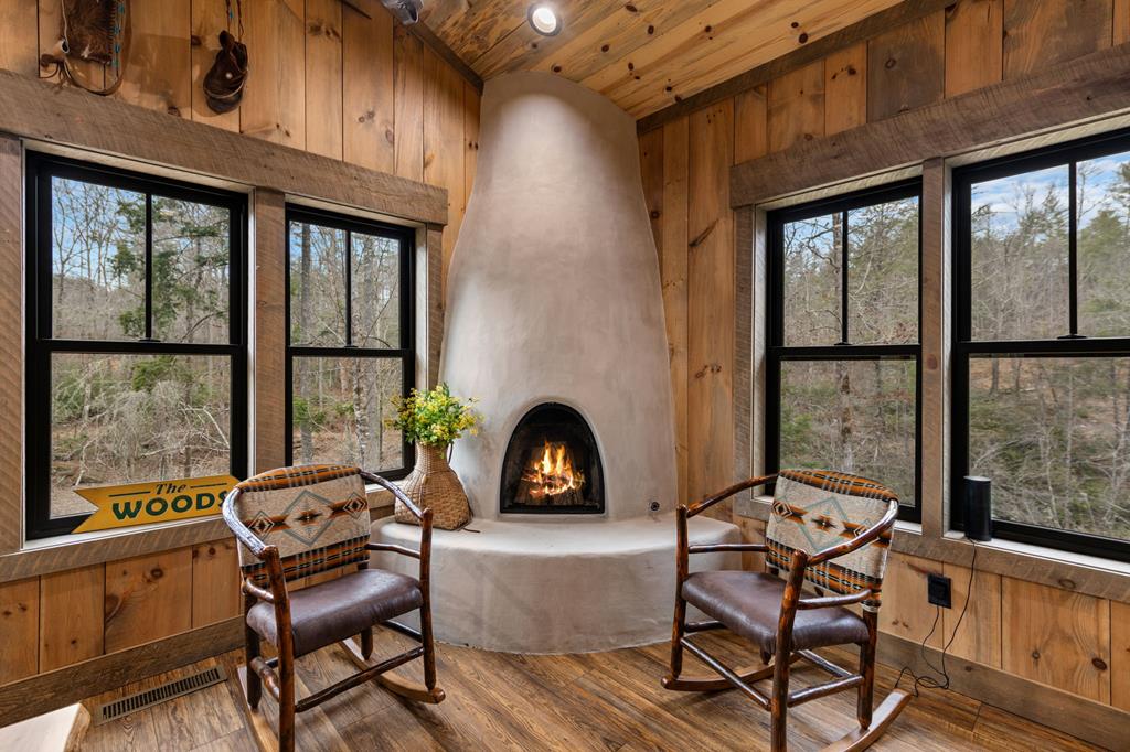 164 Waterdance Trail Blue Ridge, GA 30513 - Photo 34 of 97 a living room with furniture a fireplace and large windows