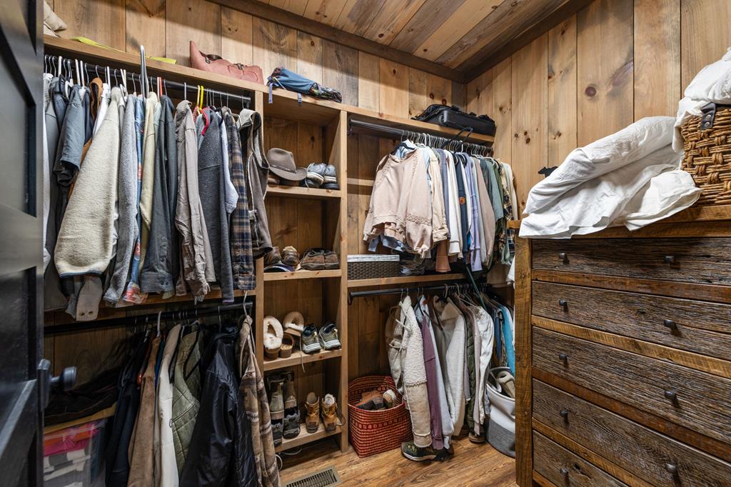 164 Waterdance Trail Blue Ridge, GA 30513 - Photo 54 of 97 a view of walk in closet with clothes and shoes