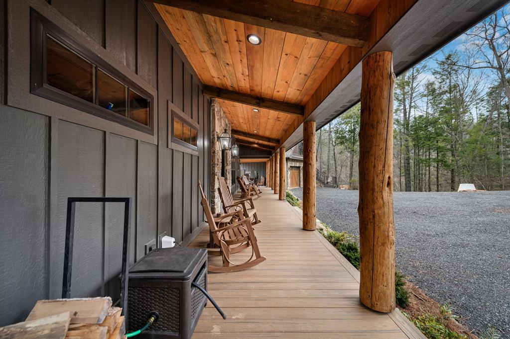 164 Waterdance Trail Blue Ridge, GA 30513 - Photo 75 of 97 a view of a balcony with chairs and wooden floor