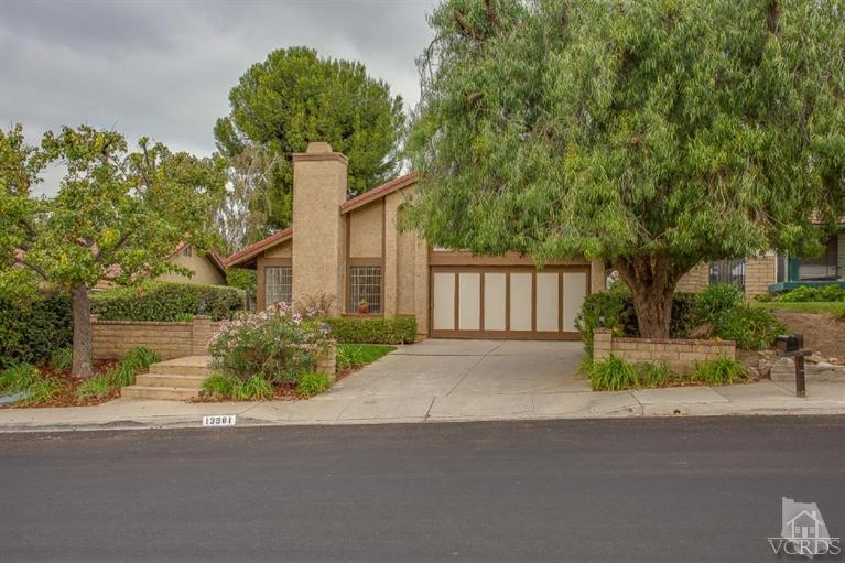 13681 Bear Valley Road Moorpark, CA 93021 - Photo 1 of 33 a front view of a house with a yard and garage