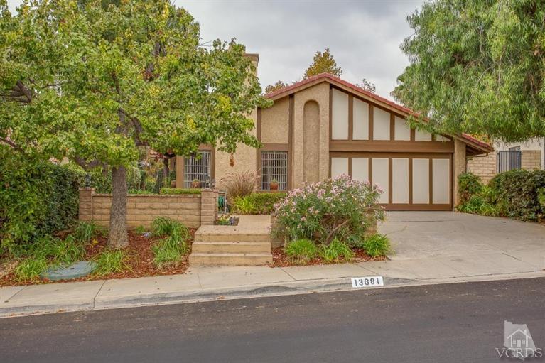 13681 Bear Valley Road Moorpark, CA 93021 - Photo 2 of 33 a front view of a house with a yard and trees