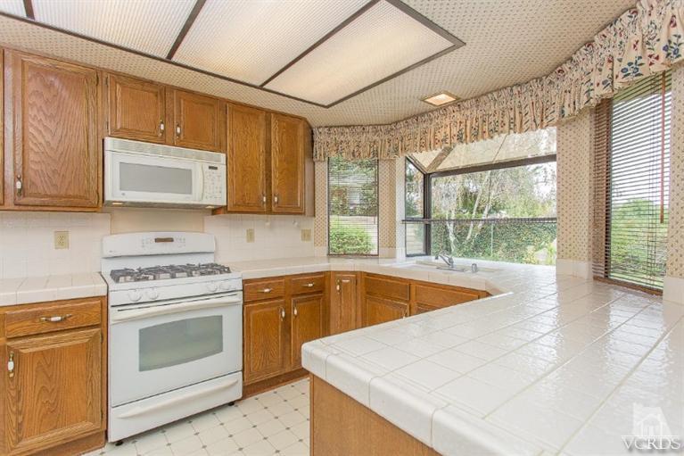 13681 Bear Valley Road Moorpark, CA 93021 - Photo 16 of 33 a kitchen with a stove sink and cabinets