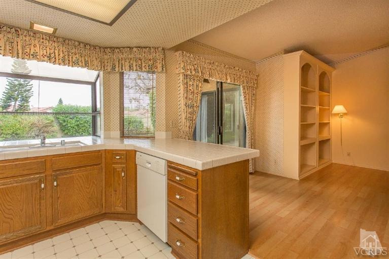 13681 Bear Valley Road Moorpark, CA 93021 - Photo 17 of 33 a kitchen with a stove a sink and a refrigerator