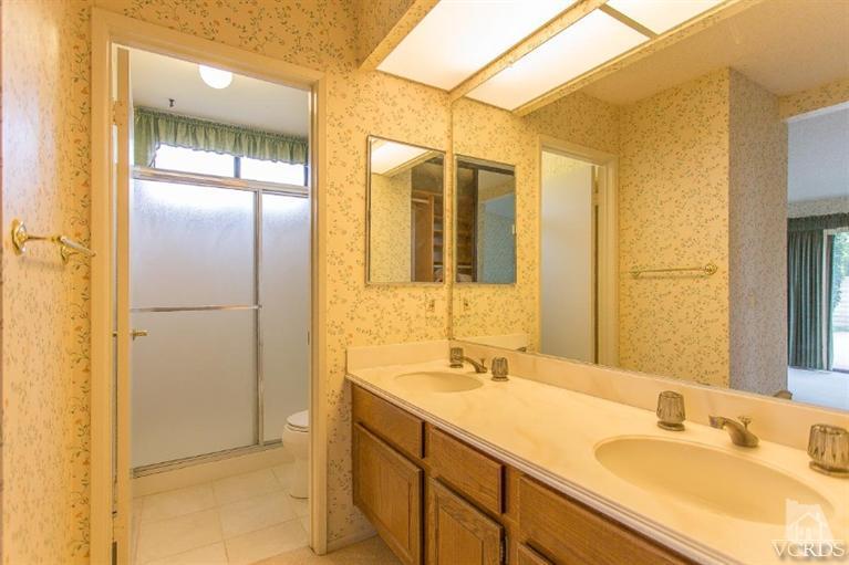 13681 Bear Valley Road Moorpark, CA 93021 - Photo 27 of 33 a bathroom with a double vanity sink and a mirror