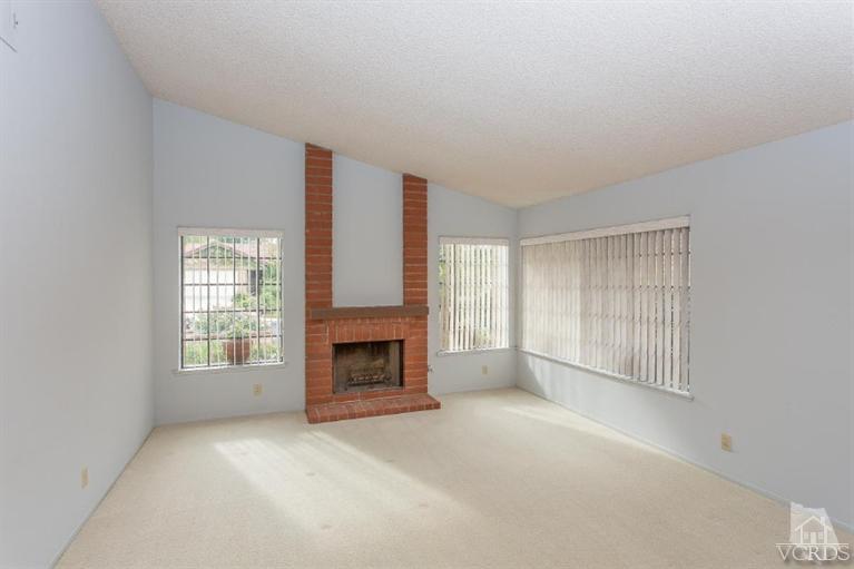 13681 Bear Valley Road Moorpark, CA 93021 - Photo 6 of 33 an empty room with fireplace and windows