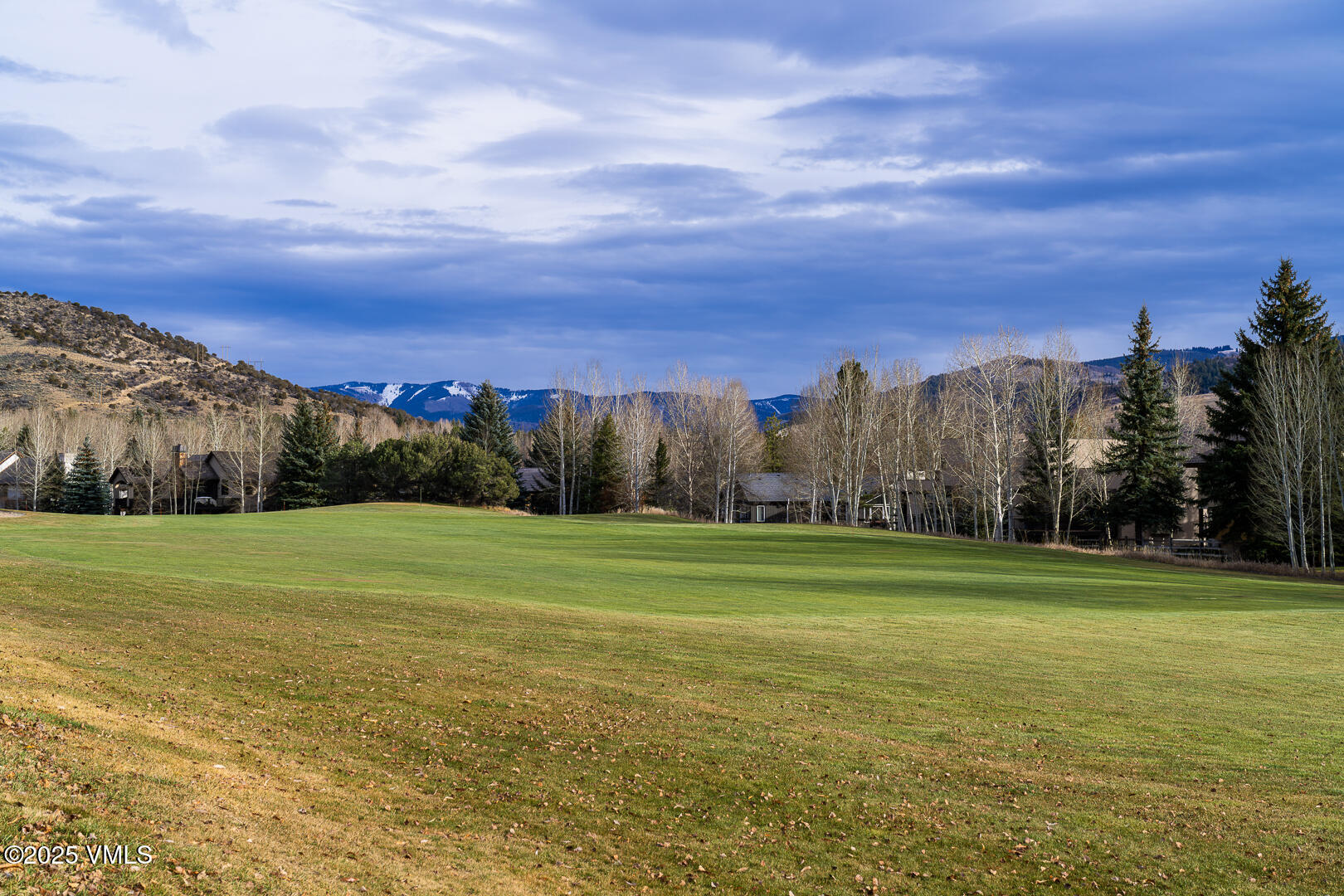 1121 Berry Creek Road, Unit B3 Edwards, CO 81632 - Photo 19 of 38 a view of a golf course with a lake