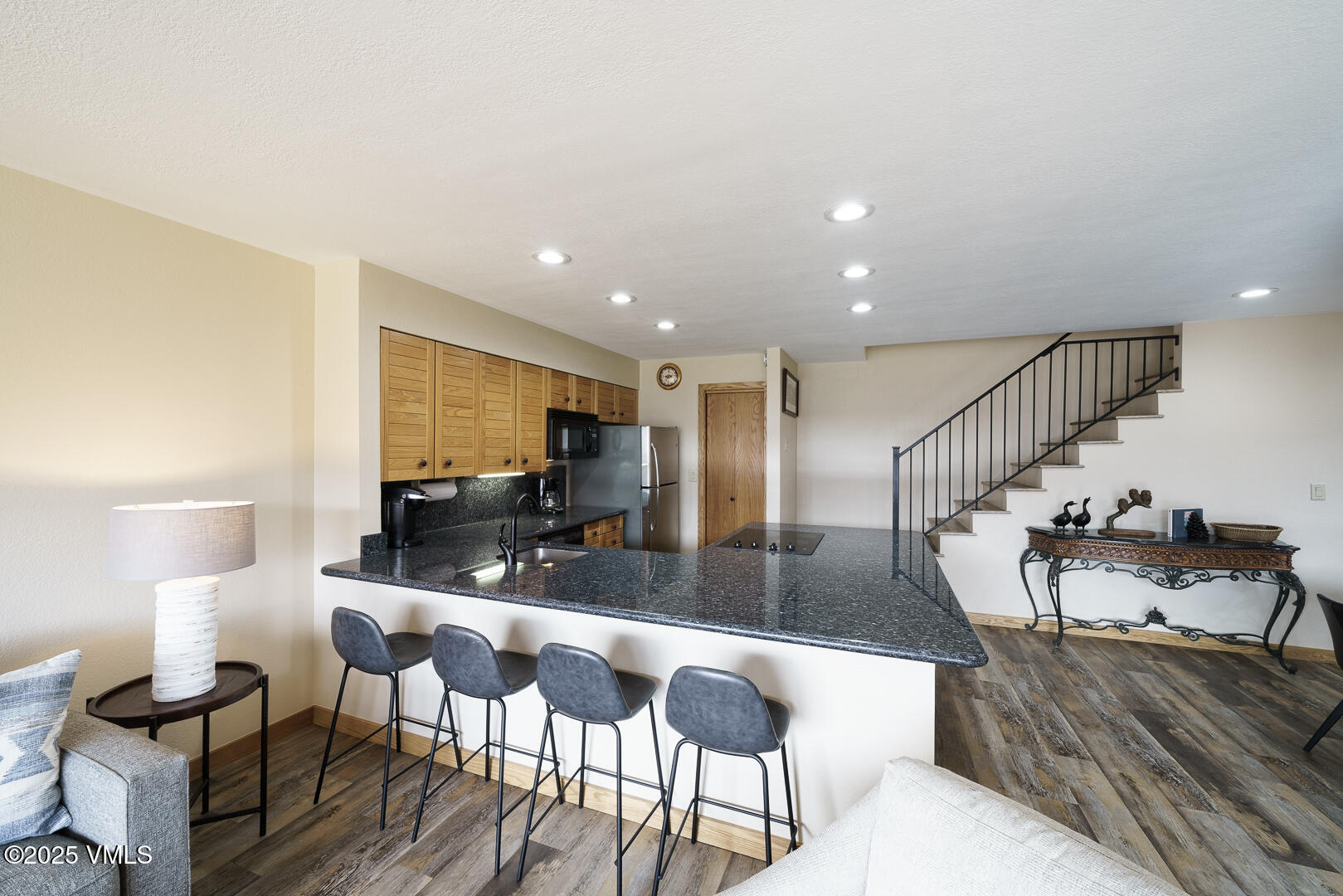 1121 Berry Creek Road, Unit B3 Edwards, CO 81632 - Photo 4 of 38 a kitchen with granite countertop lots of furniture and a view of living room