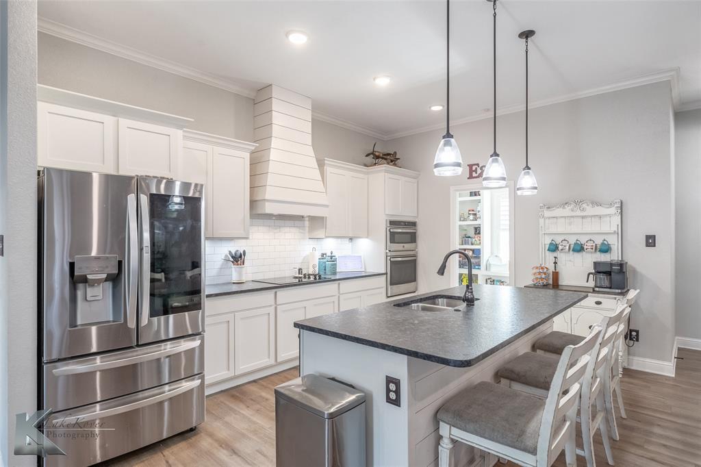 138 Lisa Lane Tuscola, TX 79562 - Photo 13 of 38 a kitchen with kitchen island a sink stove and refrigerator
