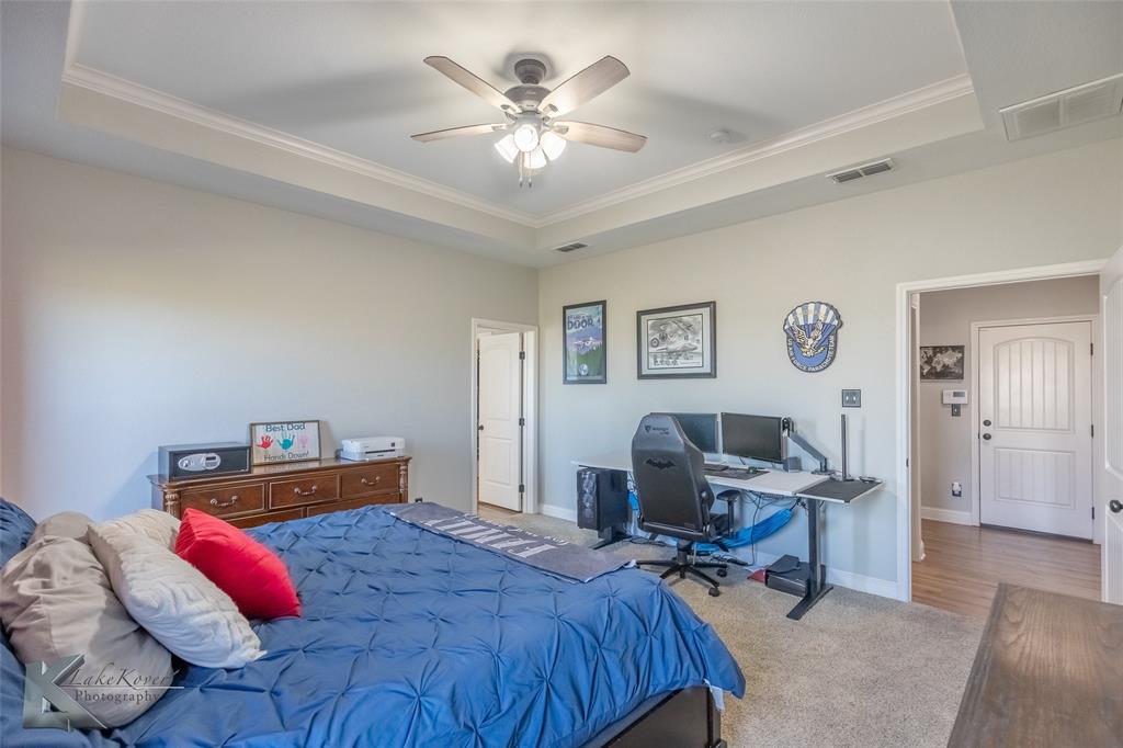 138 Lisa Lane Tuscola, TX 79562 - Photo 20 of 38 a bedroom with a bed and a chandelier