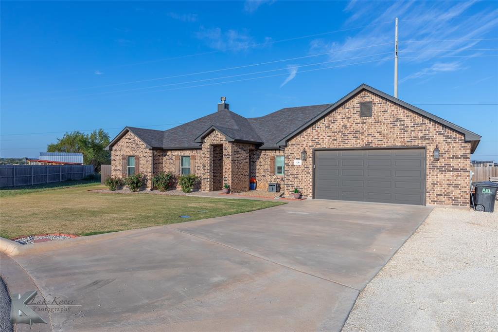 138 Lisa Lane Tuscola, TX 79562 - Photo 2 of 38 a front view of a house with a yard and garage