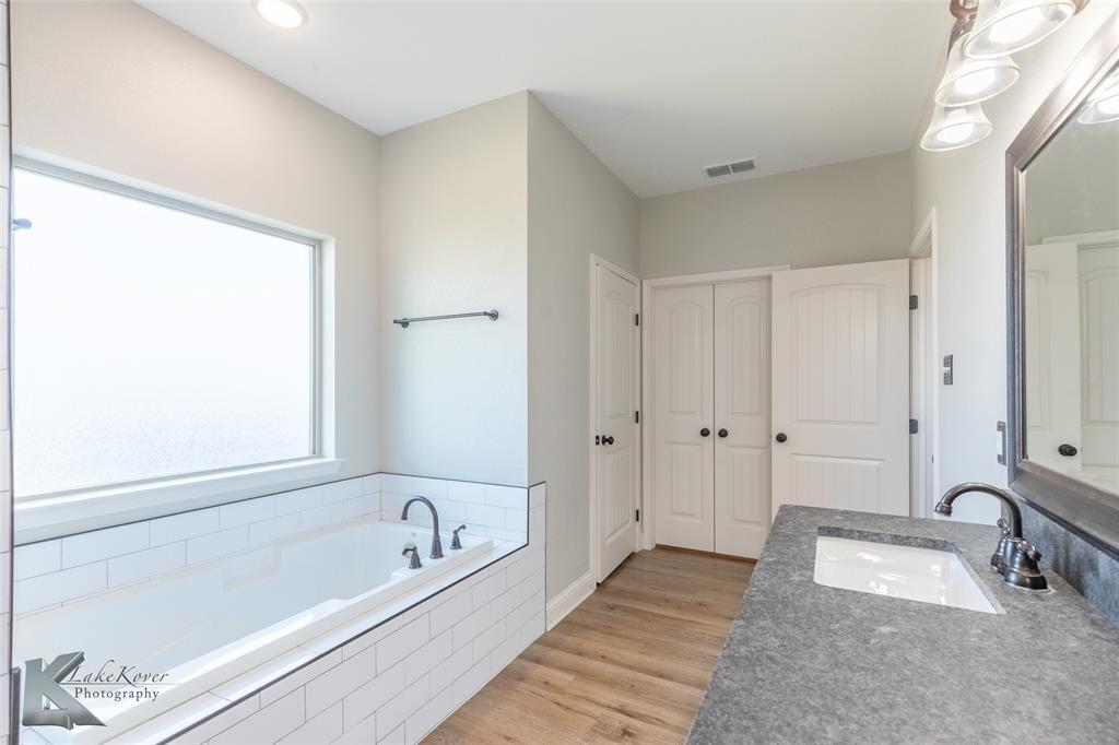 138 Lisa Lane Tuscola, TX 79562 - Photo 23 of 38 a bathroom with a tub a sink and a window
