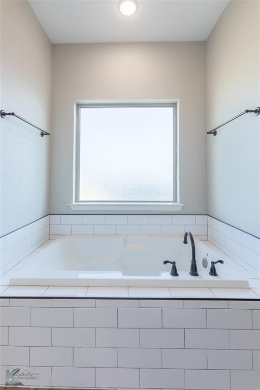138 Lisa Lane Tuscola, TX 79562 - Photo 24 of 38 a bathroom with a bathtub and a sink