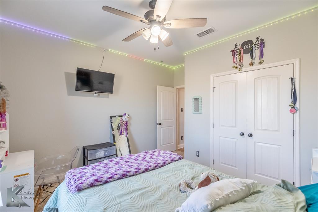 138 Lisa Lane Tuscola, TX 79562 - Photo 29 of 38 a bedroom with a bed and a flat screen tv