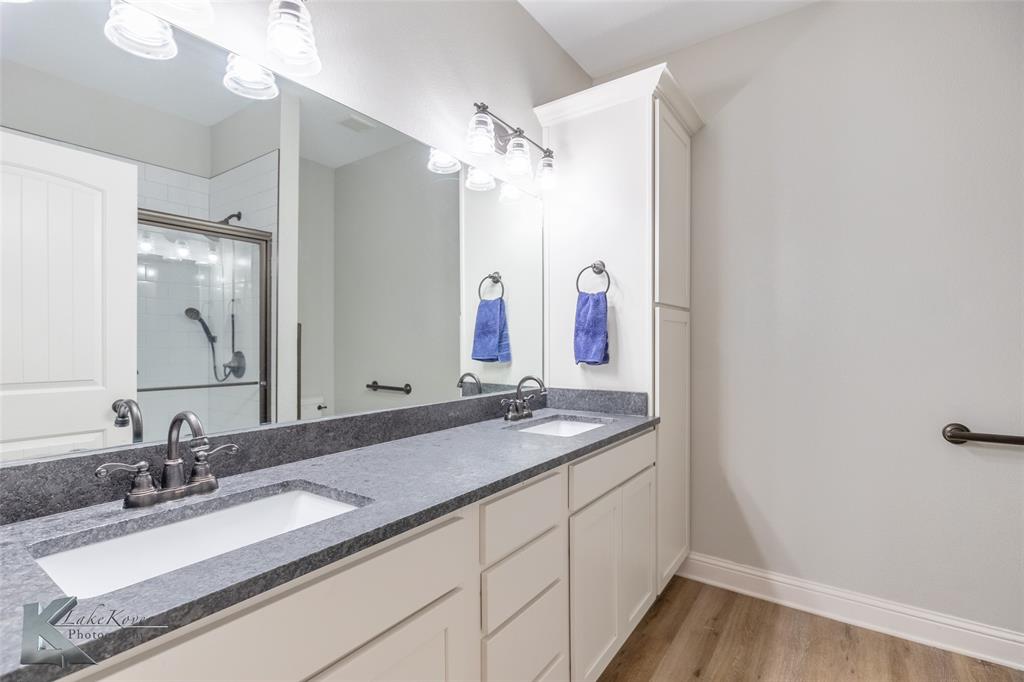 138 Lisa Lane Tuscola, TX 79562 - Photo 30 of 38 a bathroom with a granite countertop sink and a mirror