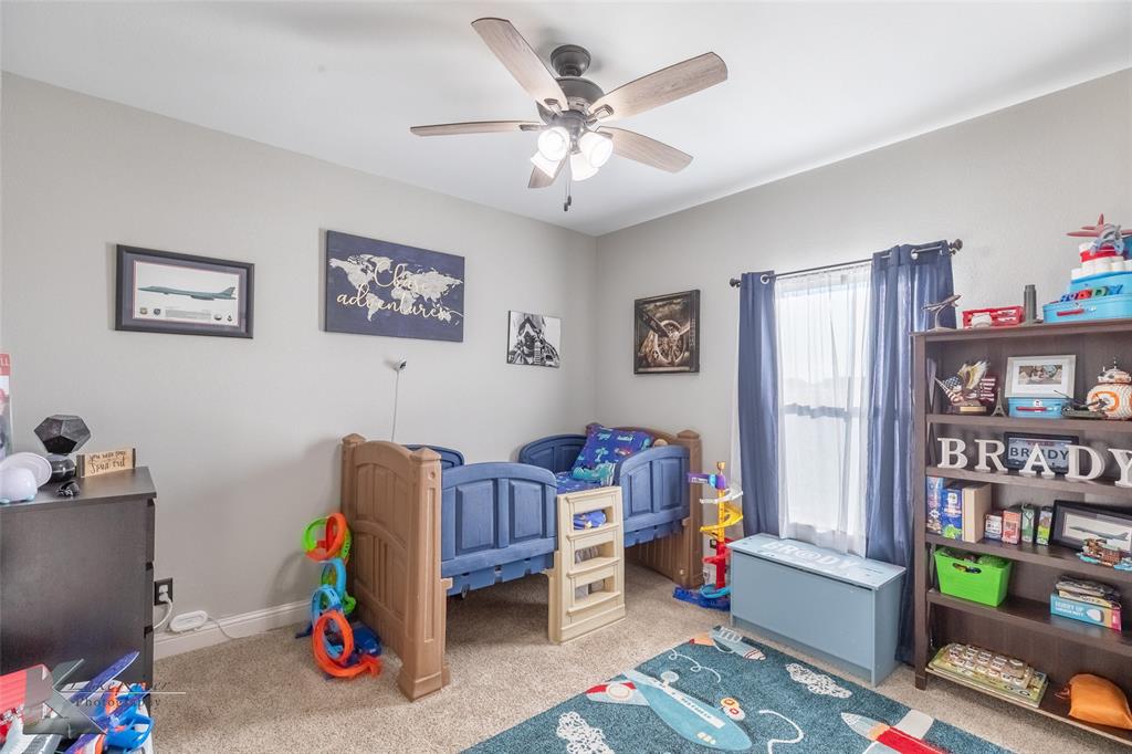 138 Lisa Lane Tuscola, TX 79562 - Photo 34 of 38 a bed room with furniture and book shelf
