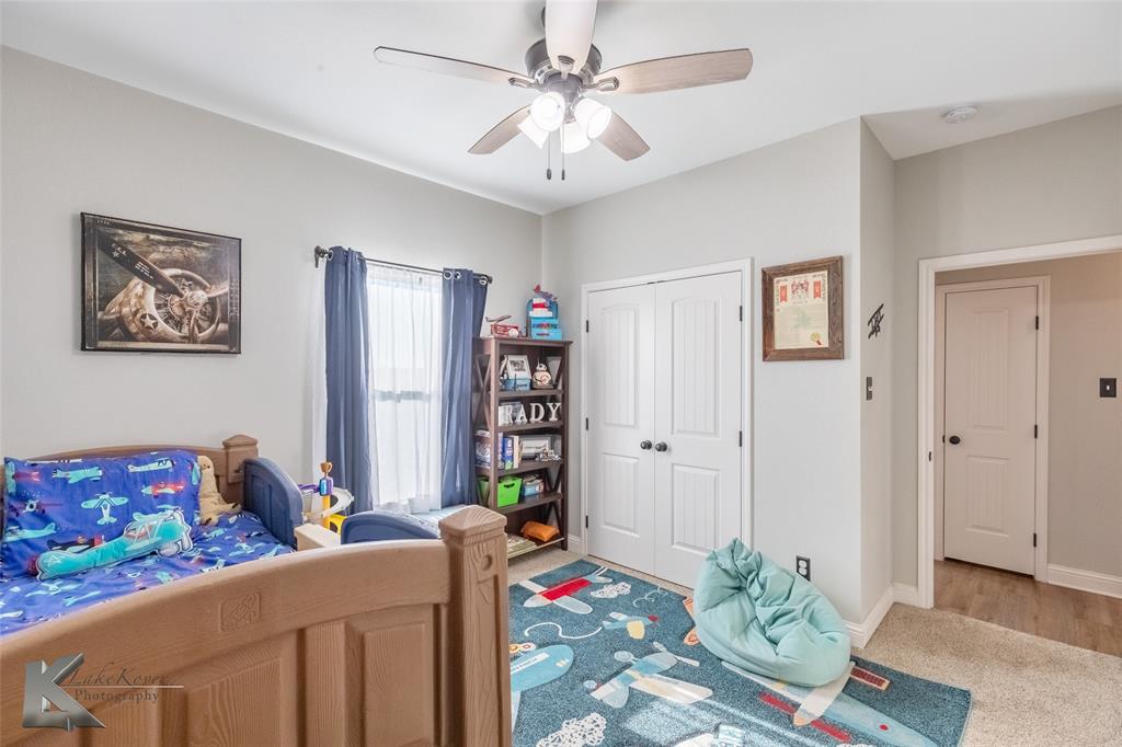 138 Lisa Lane Tuscola, TX 79562 - Photo 35 of 38 a bedroom with furniture and a book shelf