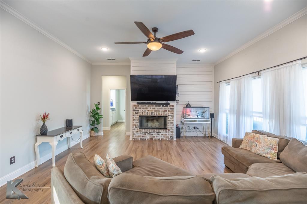 138 Lisa Lane Tuscola, TX 79562 - Photo 6 of 38 a living room with furniture a fireplace and a flat screen tv
