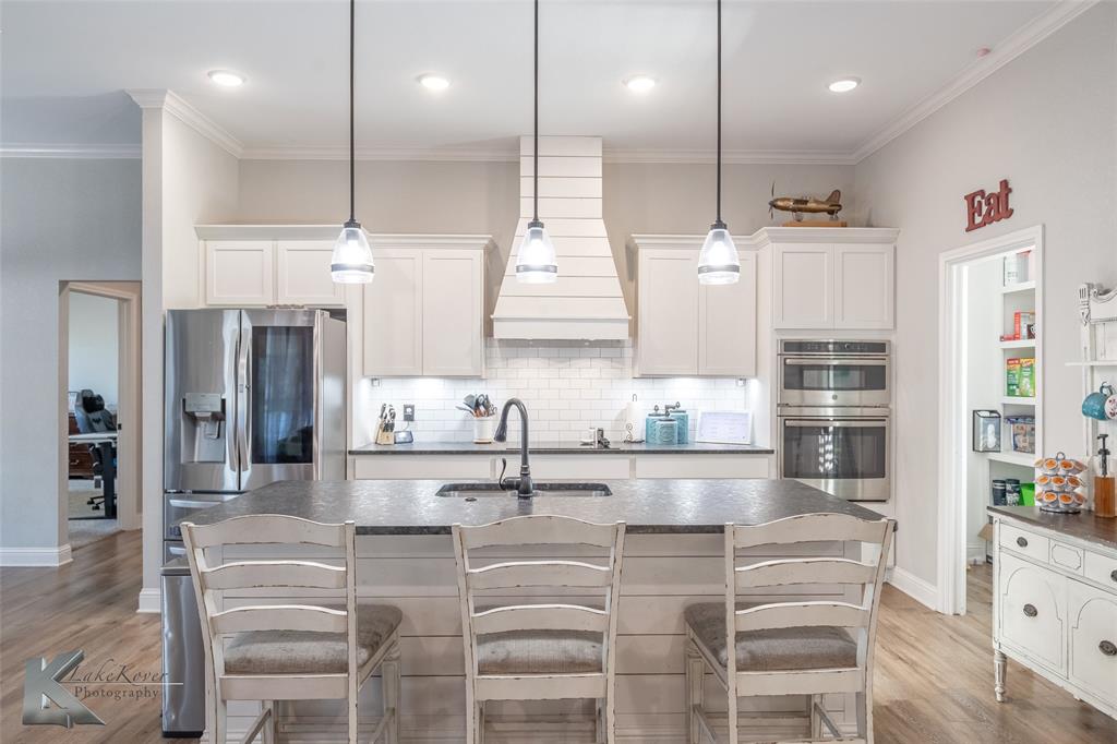 138 Lisa Lane Tuscola, TX 79562 - Photo 10 of 38 a kitchen with kitchen island cabinets and a refrigerator