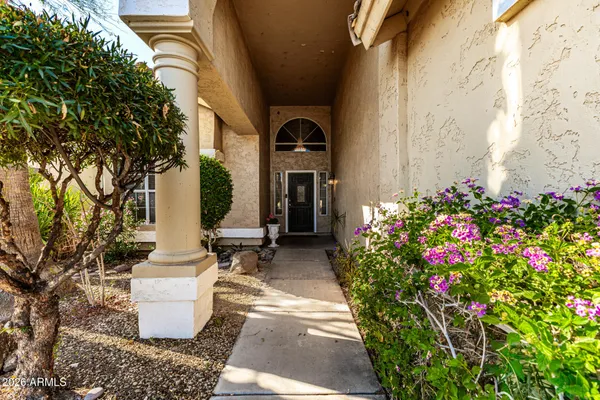 a front view of a house with flowers