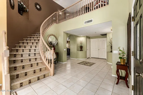 a view of a hallway with entryway dining room and hall with wooden floor