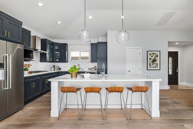 a large kitchen with a table and chairs