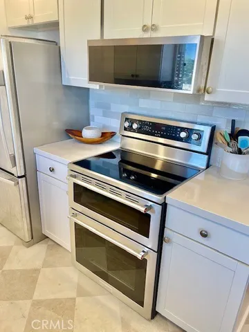 a stove top oven sitting inside of a kitchen